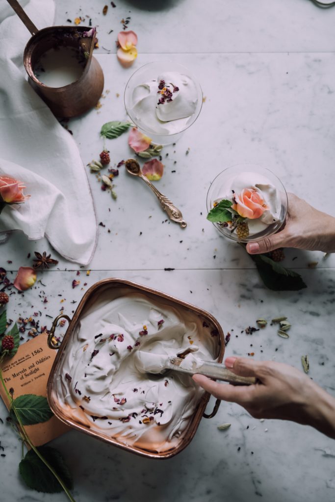 Person scooping ice cream into cup: Photo by Christiann Koepke on Unsplash